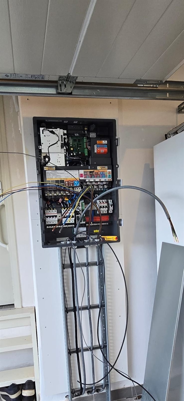 EV-lader met laadkabel aan de gevel van een woning